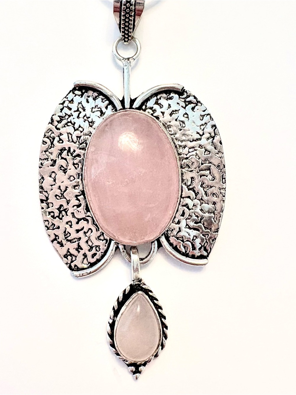 3 inch, 925 marked, 2 Rose Quartz stones, butterfly pendant on a silver chain.